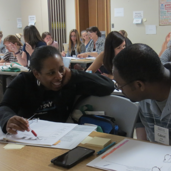 Trainer and teacher working out math problems