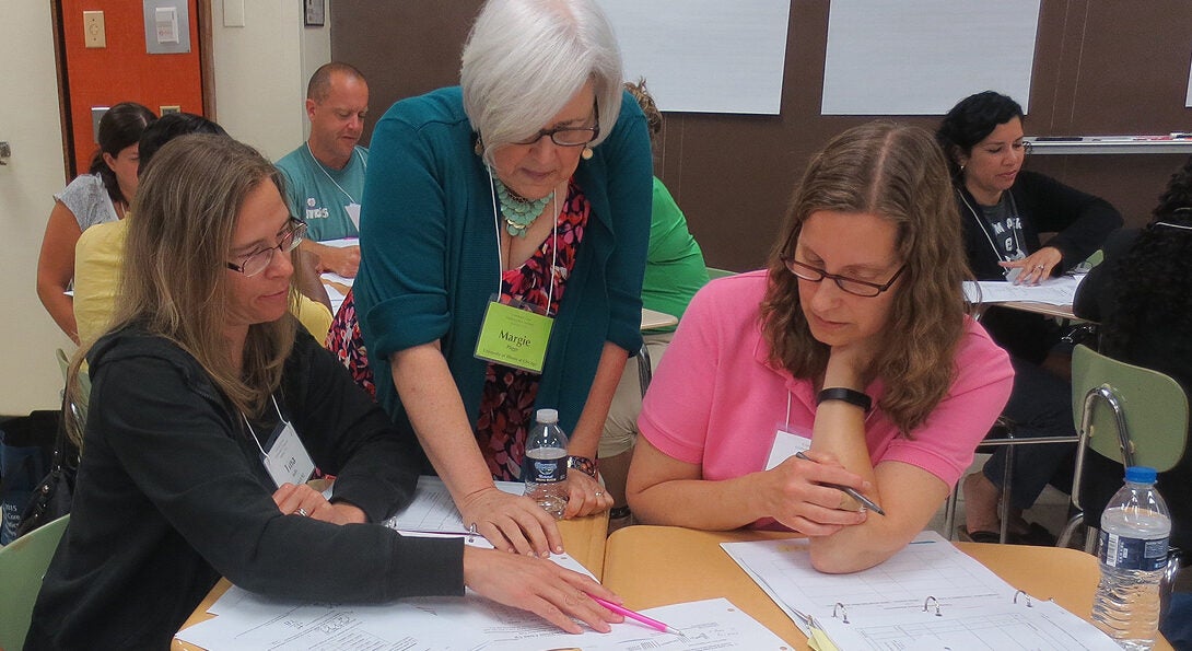 A trainer instructs participants in the EMS program